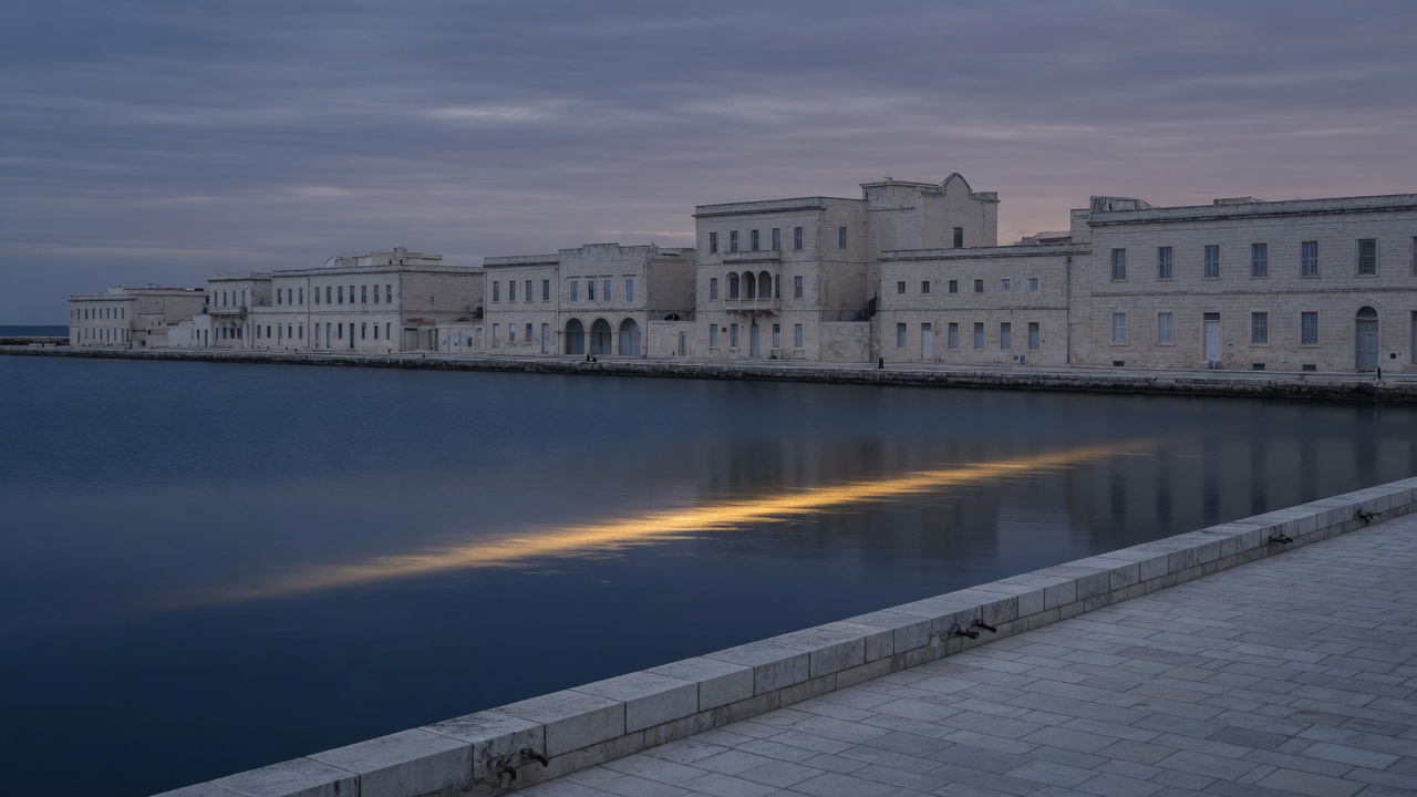 A quiet limestone harbour at dusk — abstract stand-in for Cayman operations, not a customer office.